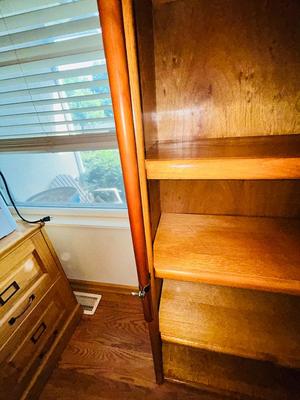 A LARGE OAK BOOKCASE WITH FLAG POLE