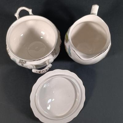 LOT 110: Johnson Bros. The Friendly Village 3-Tier Cake Stand, Butter Pat Dishes, Sugar Bowl, Creamer & More