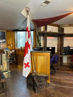 CHUNK OF WOOD WITH LIGHTED FLAG POLE AND FLAG