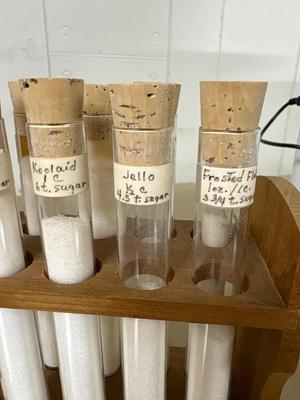 Test tube is showing sugar content of various items