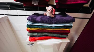 TOWEL SETS, SHOWER CURTAIN AND NICE CHROME CURVED ROD, TRASH CAN AND TOILET BRUSH HOLDER