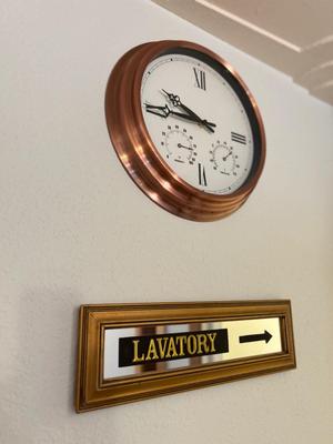 COPPER FRAMED WALL CLOCK AND LAVATORY SIGN