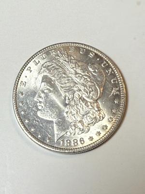 1886 UNCIRCULATED CONDITION MORGAN SILVER DOLLAR (COIN #2X4) AS PICTURED.