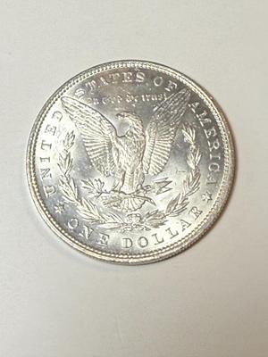 1886 UNCIRCULATED CONDITION MORGAN SILVER DOLLAR (COIN #2X4) AS PICTURED.