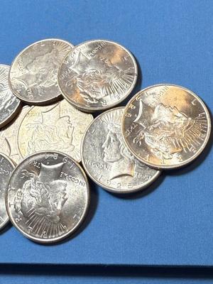 BAG #2 OF 10 DECENT SHAPE PEACE SILVER DOLLARS AT MELT SILVER PRICE AS PICTURED. (RECEIVE ALL COINS PICTURED).