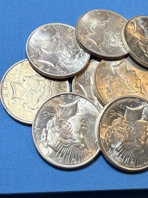 BAG #2 OF 10 DECENT SHAPE PEACE SILVER DOLLARS AT MELT SILVER PRICE AS PICTURED. (RECEIVE ALL COINS PICTURED).