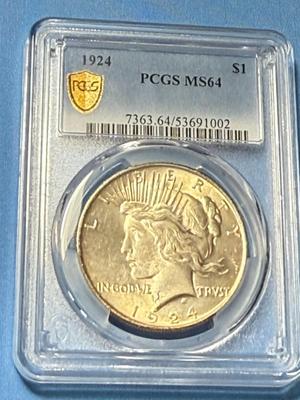 PCGS CERTIFIED 1924 MS64 LIGHTLY TONED PEACE SILVER DOLLAR AS PICTURED.