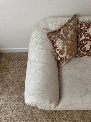 CREAM COLORED LOVESEAT WITH THROW PILLOWS