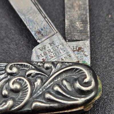 LOT 22J: Two Pairs of Antique Rimless Eyeglasses in Cases, WH Morley & Sons Pocket Knife with Case, Tiny Book Locket, and More