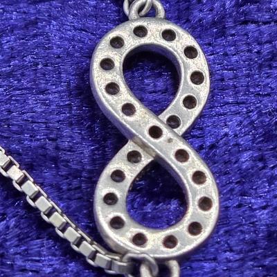 LOT 29J: Sterling Silver and Diamond Adjustable Infinity Bracelet