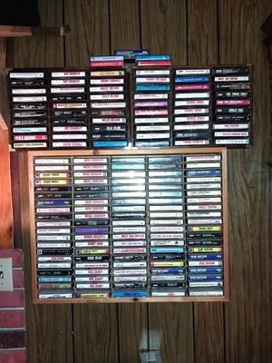 VARIETY OF CASSETTE TAPES AND WOODEN HOLDER