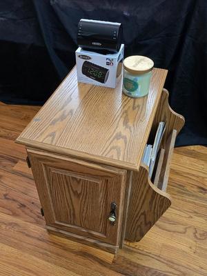 Magazine rack end table with brand new Jensen digital alarm clock and a scented candle
