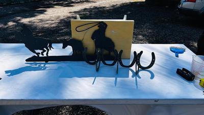 HORSESHOE COAT HOOKS AND A COWBOY IRON WALL CUTOUT