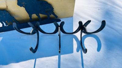 HORSESHOE COAT HOOKS AND A COWBOY IRON WALL CUTOUT
