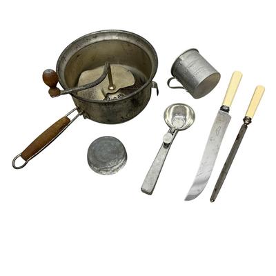 Sale Photo Thumbnail #266: Lot of Vintage Kitchenware-
Metal food mill with wooden handle, tin measuring cup , ice cream/food scoop, kitchen knife (Cooper Bros & Sons Ltd, Sheffiend England, and sharpener with cream handles, small ball jar lid