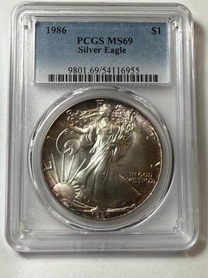 PCGS CERTIFIED 1986 MS69 TONED RIMS SILVER EAGLE DOLLAR AS PICTURED.