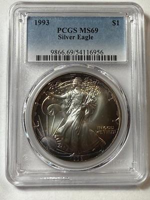PCGS CERTIFIED 1993 MS69 NICELY TONED RIMS OBV. SILVER EAGLE DOLLAR AS PICTURED.