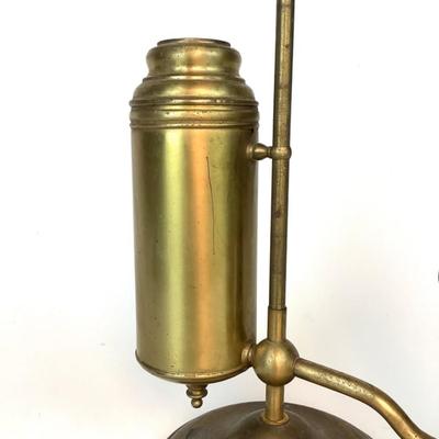 Sale Photo Thumbnail #1318: This is an old, heavy brass oil lamp made by Miller. It has a tarnished brass finish and a turnable body. The glass globe is an Aladdin brand and has a small chip on the bottom that's hidden when attached. The word "Miller" is stamped on the bottom and "E