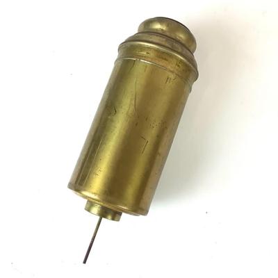 Sale Photo Thumbnail #1314: This is an old, heavy brass oil lamp made by Miller. It has a tarnished brass finish and a turnable body. The glass globe is an Aladdin brand and has a small chip on the bottom that's hidden when attached. The word "Miller" is stamped on the bottom and "E