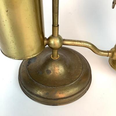 Sale Photo Thumbnail #1316: This is an old, heavy brass oil lamp made by Miller. It has a tarnished brass finish and a turnable body. The glass globe is an Aladdin brand and has a small chip on the bottom that's hidden when attached. The word "Miller" is stamped on the bottom and "E