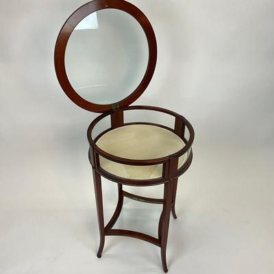 Sale Photo Thumbnail #1387: One side hinged top, has removable bottom glass insert, has brass/gold metal hardware
Measures: 19.5" diameter x 27.5" high