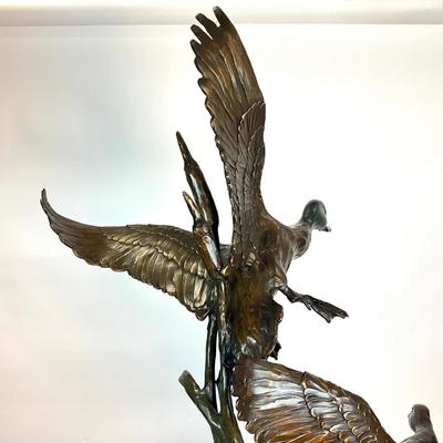 Sale Photo Thumbnail #1398: Against the Wind is an elegant rendition of a pair of mallards cutting through the wind for a landing .  The design incorporates beautiful "S" curves and circular motion rising out of an integrated formal bronze base.  This piece is suitable for indoor, o