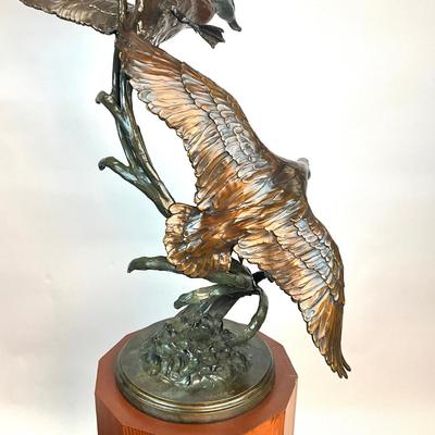 Sale Photo Thumbnail #1399: Against the Wind is an elegant rendition of a pair of mallards cutting through the wind for a landing .  The design incorporates beautiful "S" curves and circular motion rising out of an integrated formal bronze base.  This piece is suitable for indoor, o