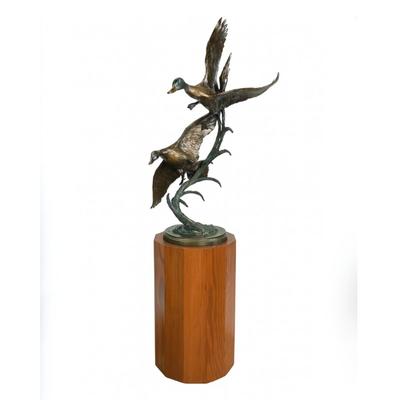 Sale Photo Thumbnail #1393: Against the Wind is an elegant rendition of a pair of mallards cutting through the wind for a landing .  The design incorporates beautiful "S" curves and circular motion rising out of an integrated formal bronze base.  This piece is suitable for indoor, o