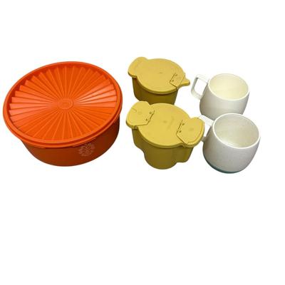 Sale Photo Thumbnail #462: Tupperware Lot of 3 Plus 2 Vtg Mugs
-large orange Tupperware container with sunburst lid, 70s design
-2 mustard yellow Tupperware one cup containers with hinged lids
-two matching retro mugs w/ blue base marked Bopp-Decker Plastics Inc, Birmingham Mich., 