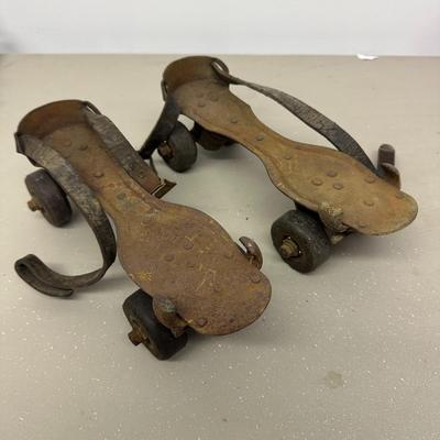 Sale Photo Thumbnail #538: Vintage Adjustable Metal Roller Skates w Leather Straps and Hard Composite Wheels, early 20th Century, patent date Nov. 27, 1917. Visible rust, wear, and aging.