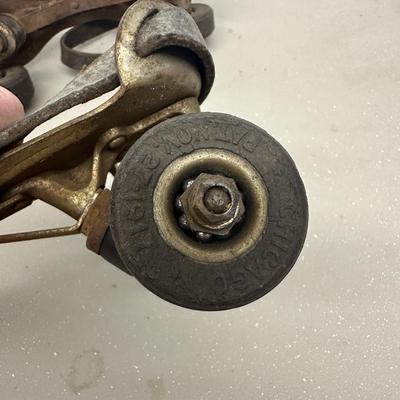 Sale Photo Thumbnail #539: Vintage Adjustable Metal Roller Skates w Leather Straps and Hard Composite Wheels, early 20th Century, patent date Nov. 27, 1917. Visible rust, wear, and aging.