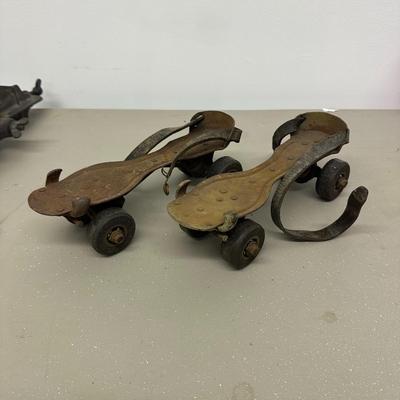 Sale Photo Thumbnail #537: Vintage Adjustable Metal Roller Skates w Leather Straps and Hard Composite Wheels, early 20th Century, patent date Nov. 27, 1917. Visible rust, wear, and aging.