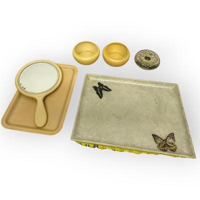 Sale Photo Thumbnail #735: Vintage Dressing Table Lot 6 Items: 2 Trays (one w/ Butterflies) , Mirror, 2 Bowls, and a Candleholder
Item's appear plastic except the candleholder (ceramic?)
