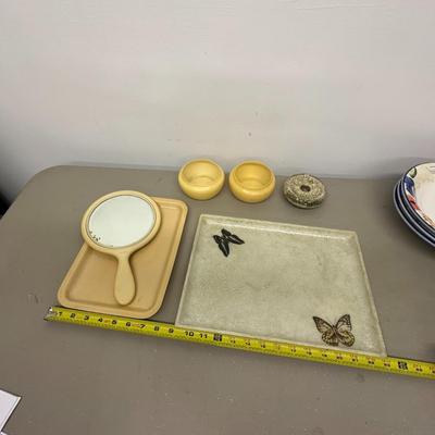 Sale Photo Thumbnail #741: Vintage Dressing Table Lot 6 Items: 2 Trays (one w/ Butterflies) , Mirror, 2 Bowls, and a Candleholder
Item's appear plastic except the candleholder (ceramic?)