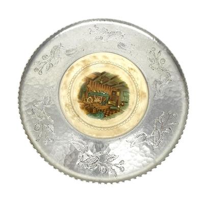 Sale Photo Thumbnail #772: Farberware Brooklyn NY Wrought Aluminum & Ceramic Center Plate with Cabin Scene
Approx. 16" across, 1940s-50s; Americana. Some crazing on plate and age discoloration.