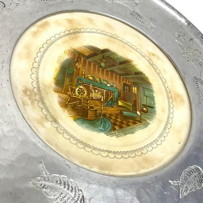 Sale Photo Thumbnail #775: Farberware Brooklyn NY Wrought Aluminum & Ceramic Center Plate with Cabin Scene
Approx. 16" across, 1940s-50s; Americana. Some crazing on plate and age discoloration.