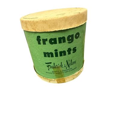 Sale Photo Thumbnail #878: Box of Misc. Kitchen/Decor items- 4 Green Plate Chargers, Embroidered Picture, 2 Ceramic Pieces, Basket, and  Frango Mints container