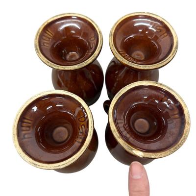 Sale Photo Thumbnail #921: 4 Hull Pottery Tall Brown Stemmed Mugs - one has chip on base as shown in photo