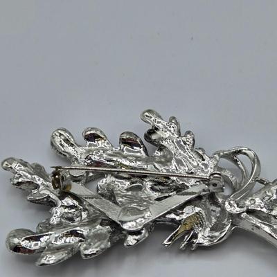 LOT 93: Multiple Pairs of Clip Earrings, Brooches, Silver-tone Chain with Winter Charms, and More