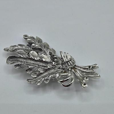 LOT 93: Multiple Pairs of Clip Earrings, Brooches, Silver-tone Chain with Winter Charms, and More