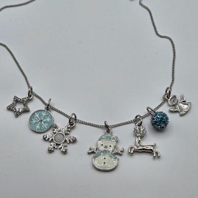 LOT 93: Multiple Pairs of Clip Earrings, Brooches, Silver-tone Chain with Winter Charms, and More