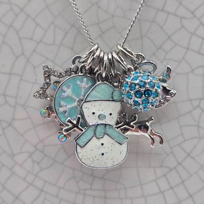 LOT 93: Multiple Pairs of Clip Earrings, Brooches, Silver-tone Chain with Winter Charms, and More