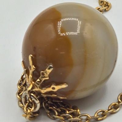 LOT 139: Two Round Polished Agate Pendants on Gold-tone Chains