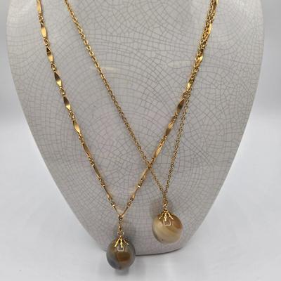 LOT 139: Two Round Polished Agate Pendants on Gold-tone Chains