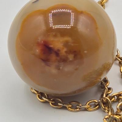 LOT 139: Two Round Polished Agate Pendants on Gold-tone Chains