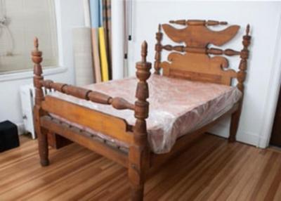 Sale Photo Thumbnail #1495: Four post wooden rope bed with acorn finials and rolling pin headboard and footboard. Metal hardware screw-in side rail construction. Designed for settlers traveling by covered wagon, a rope lattice work to support a down filled mattress. This bed does co