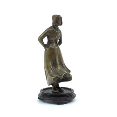 Sale Photo Thumbnail #1570: Beautiful woman standing with wind blowing skirt bronze figure. Mounted on round base , has a cut over top of her left foot around ankle area. Measuring 6.25" high