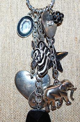 Marked "©bebe'' CHARMS NECKLACE with Elephant, Star, Hearts, Zebra, Bejeweled Black Ball & Oval and Lobster Clasp...