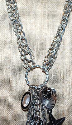 Marked "©bebe'' CHARMS NECKLACE with Elephant, Star, Hearts, Zebra, Bejeweled Black Ball & Oval and Lobster Clasp...