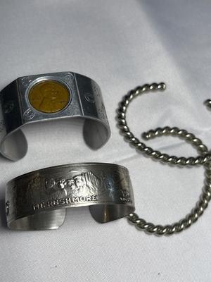 Sale Photo Thumbnail #63: Lucky horseshoe/shamrock & 1945 wheat penny bracelet, Mt Rushmore bracelet & 2 silver bracelets
